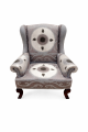 Elegant wingback armchair with Suzani fabric.png